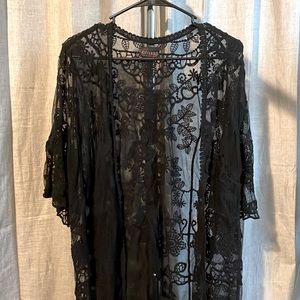 Black lace cardigan. Sleeves are quarter length.